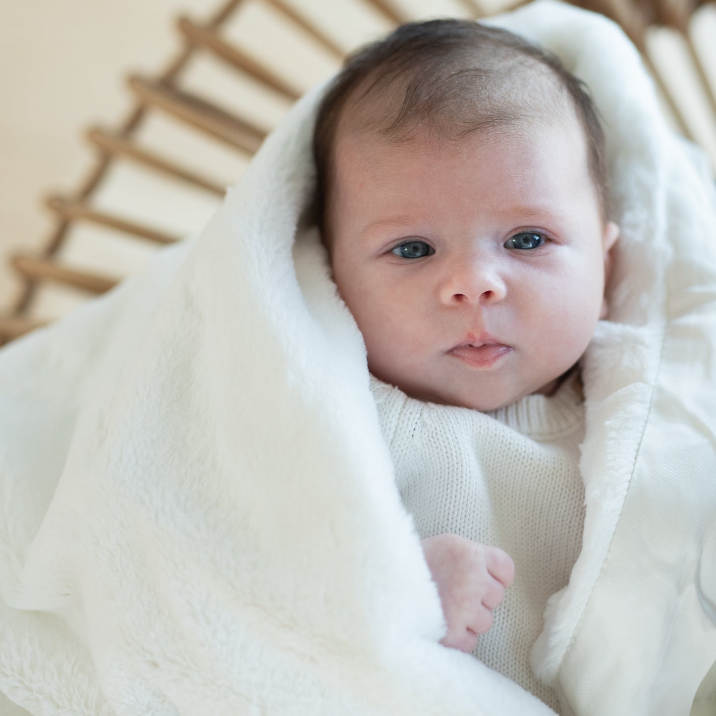 Baby wrapped in a white luxury super soft Townhouse Blanket Company receiving blanket.